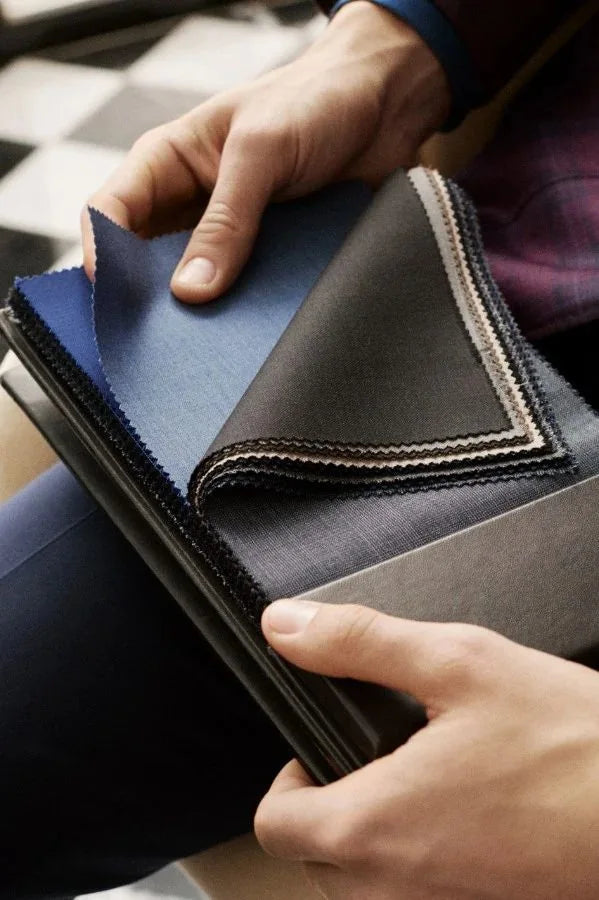 Fabric swatches examined by hand